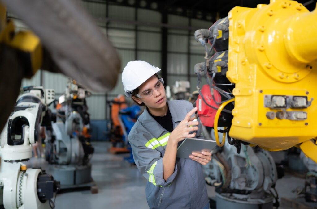 a-female-engineer-installs-a-program-on-a-robotics-arm-in-a-robot-warehouse-1-1-e1706424555548.jpg